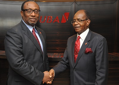 Chief Israel Ogbue, outgoing chairman, (right) congratulating Ambassador Joe new chairman, Keshi during the meeting of the Board of Directors of United Bank for Africa Plc in Lagos.